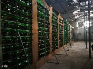 A modern bitcoin mining farm with rows of mining rigs
